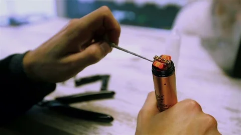 Vape. Male hands regulate electronic cigarette coils. Stock Footage 73178518