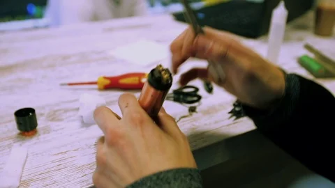 Vape. Male hands regulate electronic cigarette coils. Stock Footage 73178612