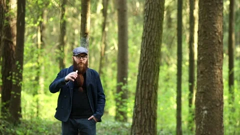 Vape man. Bearded man in a cap and glasses smokes an electronic cigarette. Stock Footage 107984609
