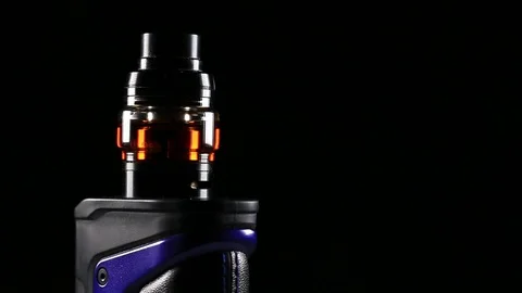 Vape Mod Electronic Cigarette Spinning Over Black Background with Vape Fog Video stock 103120899