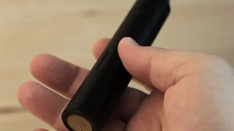 Vape pen or vaping device in man hand close up, macro. Mech mod with RDA Stock Footage 89403118