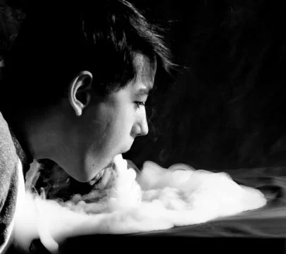 Vape trick waterfall in performance of vaper on dark background Stock Photos