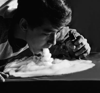 Vape trick waterfall in performance of vaper on dark background Stock Photos