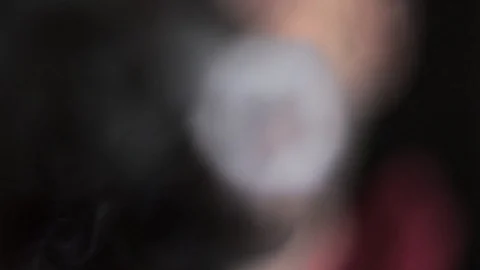 cigarette electronique vuse Vaper blows multiple smoke rings into camera, slow motion