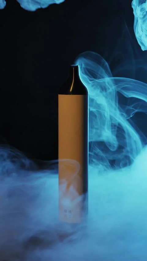 Vaping Device Surrounded by Colorful Atmospheric Smoke Stock Footage 325836141