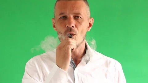 Vaping e cigarette in front of  green background Stock Footage 50472691