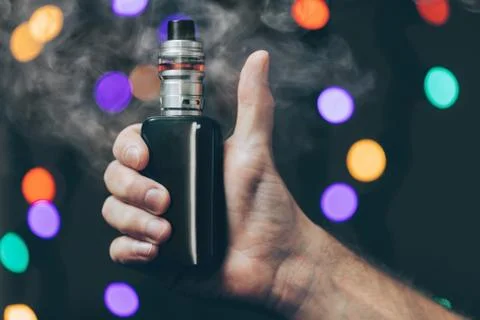 Vaping e-liquid from an electronic cigarette Stock Photos