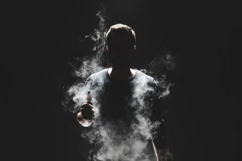 Vaping e-liquid from an electronic cigarette Stock Photos