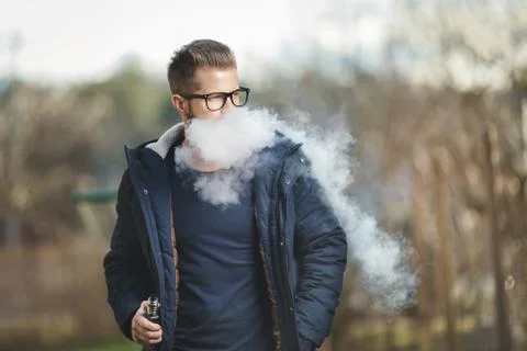 Vaping e-liquid from an electronic cigarette Stock Photos