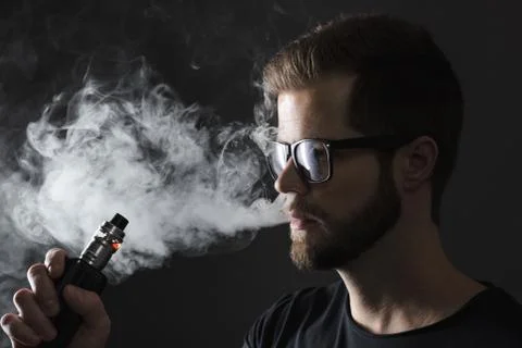 Vaping e-liquid from an electronic cigarette Stock Photos