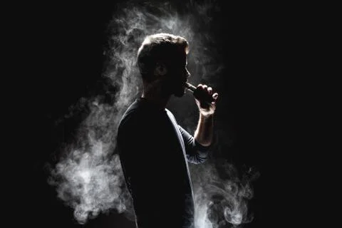 Vaping e-liquid from an electronic cigarette Stock Photos