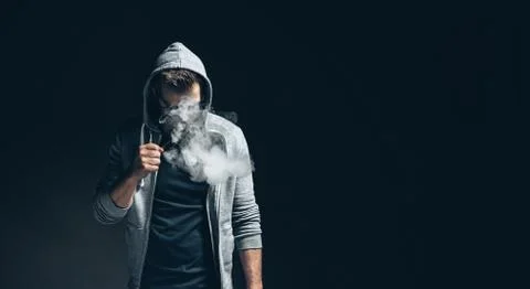 Vaping e-liquid from an electronic cigarette Stock Photos