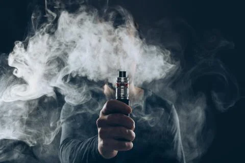 Vaping e-liquid from an electronic cigarette Stock Photos