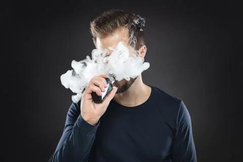 Vaping e-liquid from an electronic cigarette Stock Photos