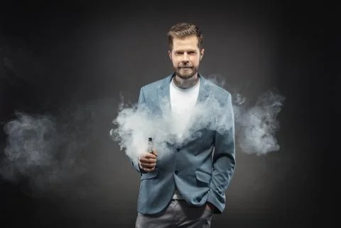 Vaping e-liquid from an electronic cigarette Stock Photos