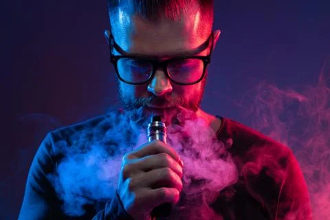 Vaping e-liquid from an electronic cigarette Stock Photos
