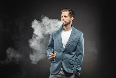 Vaping e-liquid from an electronic cigarette Stock Photos