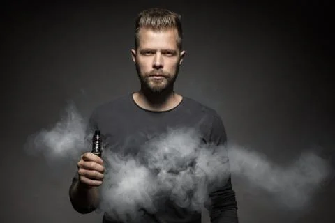 Vaping e-liquid from an electronic cigarette Stock Photos