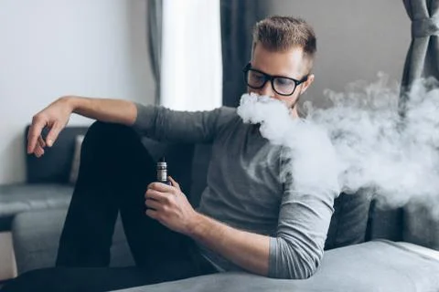 Vaping e-liquid from an electronic cigarette Stock Photos