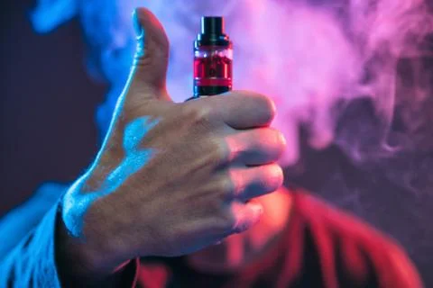 Vaping e-liquid from an electronic cigarette Stock Photos