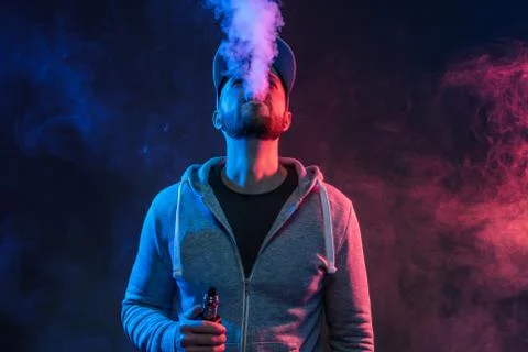 Vaping e-liquid from an electronic cigarette Stock Photos