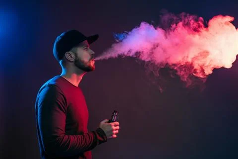 Vaping e-liquid from an electronic cigarette Stock Photos