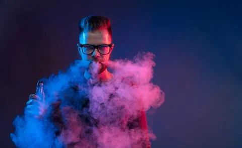 Vaping e-liquid from an electronic cigarette Stock Photos