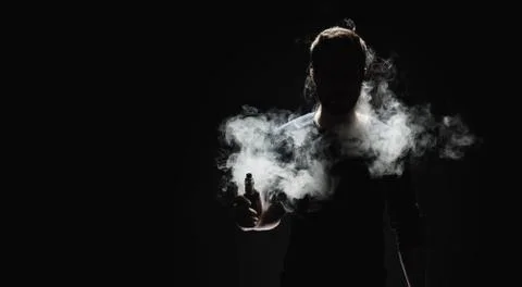 Vaping e-liquid from an electronic cigarette Stock Photos