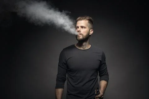 Vaping e-liquid from an electronic cigarette Stock Photos