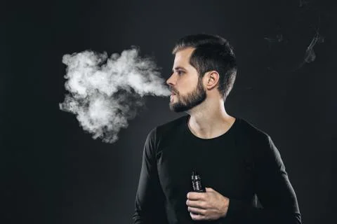 Vaping e-liquid from an electronic cigarette Stock Photos