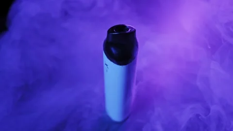Vaping Electronic Cigarette with Thick Purple Smoke Stock Footage 326314204