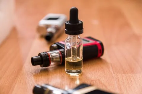Vaping electronic mod and vape liquid Stock Photos
