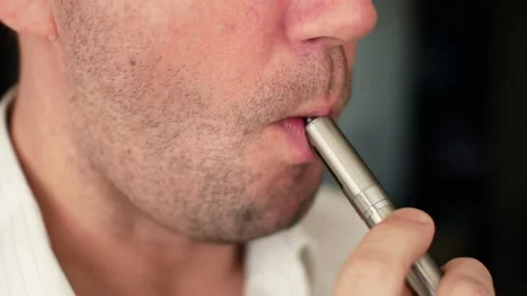 Vaping smoking electronic cigarettes. A man inhales vapor of an vape Stock Footage 133741775