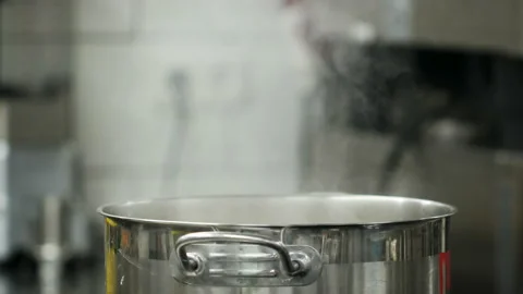 Vapour clouds rising from boiling water in pan on stove. Media. Steam and white Stock Footage 158998638