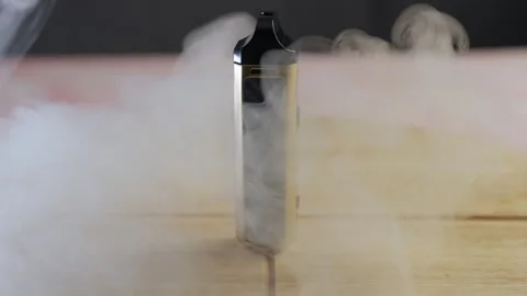 Vapour Clouds Travelling Round A Static Electronic Cigarette Pen. Vídeos de archivo 275860544