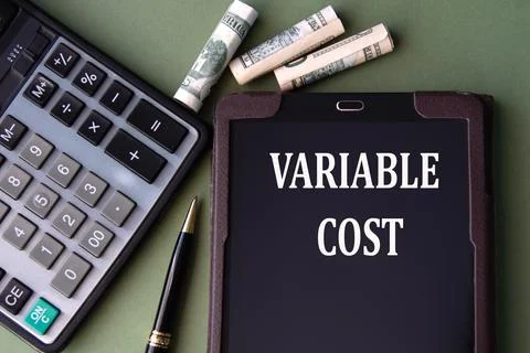 VARIABLE COST - words in an electronic notebook on the background of a calc.. Stock Photos