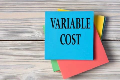 VARIABLE COST - words on note paper on wooden light background Stock-Fotos
