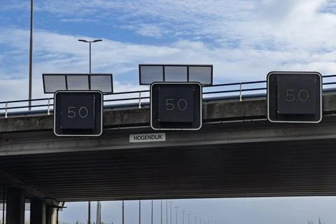 Variable message signs displaying a "50" km h speed limit are mounted beneath Stock Photos
