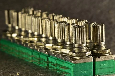 Variable single-turn carbon twin resistors in a row of twos on a desktop. Rea 스톡 사진