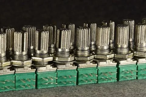 Variable single-turn carbon twin resistors in a row of twos on a desktop. Rea Stock Photos