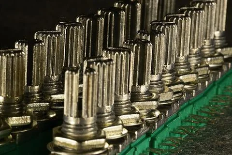 Variable single-turn carbon twin resistors in a row of twos on a desktop. Rea Stock Photos