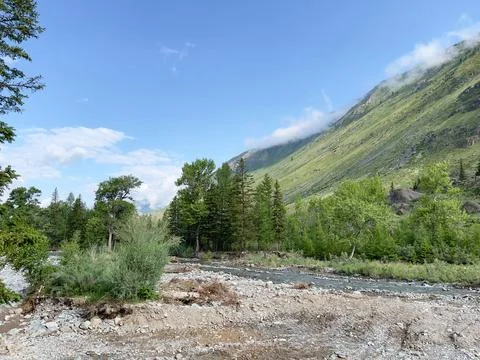 Variable weather in mountainous terrain. Clouds on the background of mountains. Stock-Fotos
