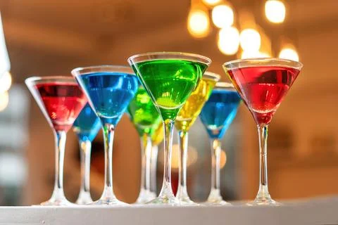 Variation alcoholic drinks served on bar counter. Colored drinks in glasses. 스톡 사진