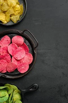 Variation different potato chips on black dark stone table background, top view 스톡 사진