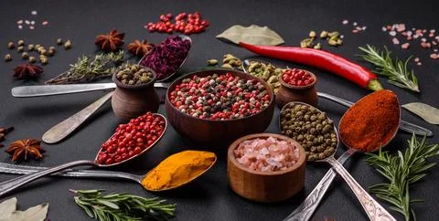 Variation of spices in metal spoons paprika, turmeric, cardamom, a mixture of Stock Photos