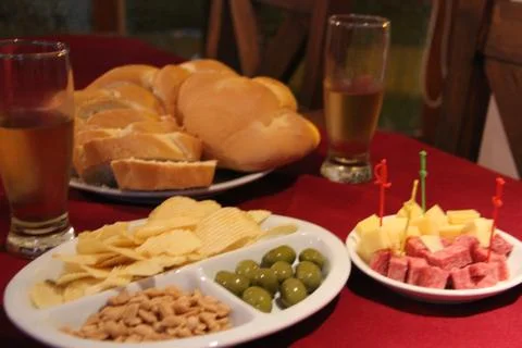 Variations of cheese and salami on table Stock Photos