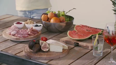 Varied aperitif with cold cuts, fresh fruits, drinks, cheese. Group of friends 動画素材 155681133