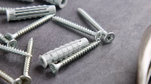 A Varied Selection of Screws and Handy Tools Displayed on a Work Surface Ready Video stock 291216685