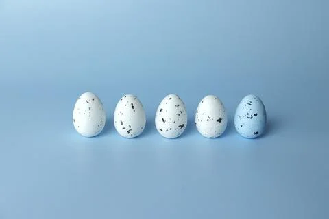 Variegated Easter eggs on a blue monochromatic background. Stock Photos