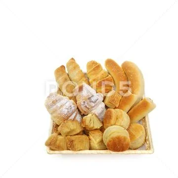 Variety assortment of baked pastry products in a wicker or bread basket over Stock Photos